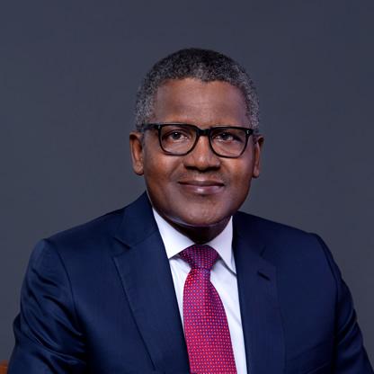 Aliko Dangote standing in front of Dangote industrial refinery and manufacturing plants in Nigeria